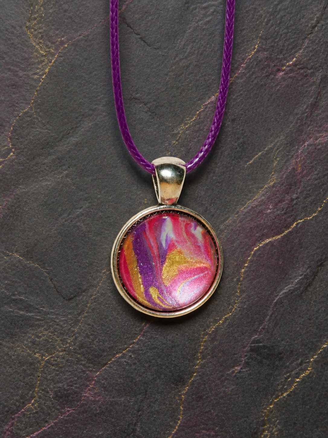 Close-up of the hand-painted Magenta Strata resin pendant
