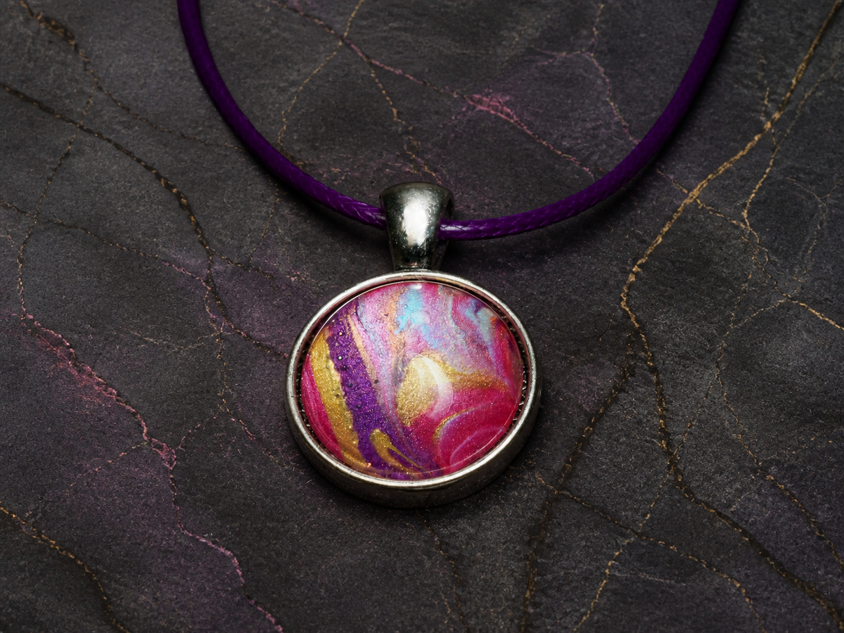 Front view of the magenta violet and gold painted pendant