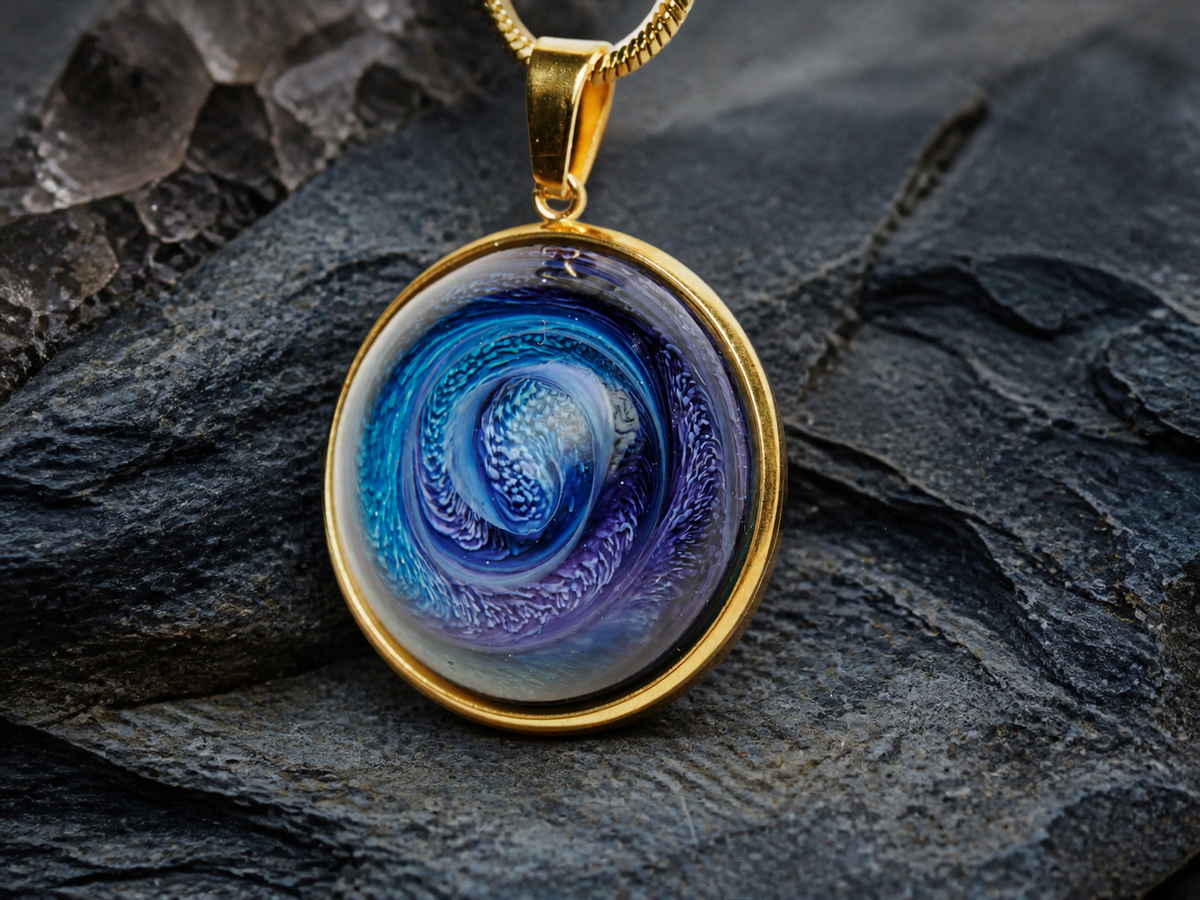 Round 18K gold-plated pendant with blue-violet ink and resin art on dark slate