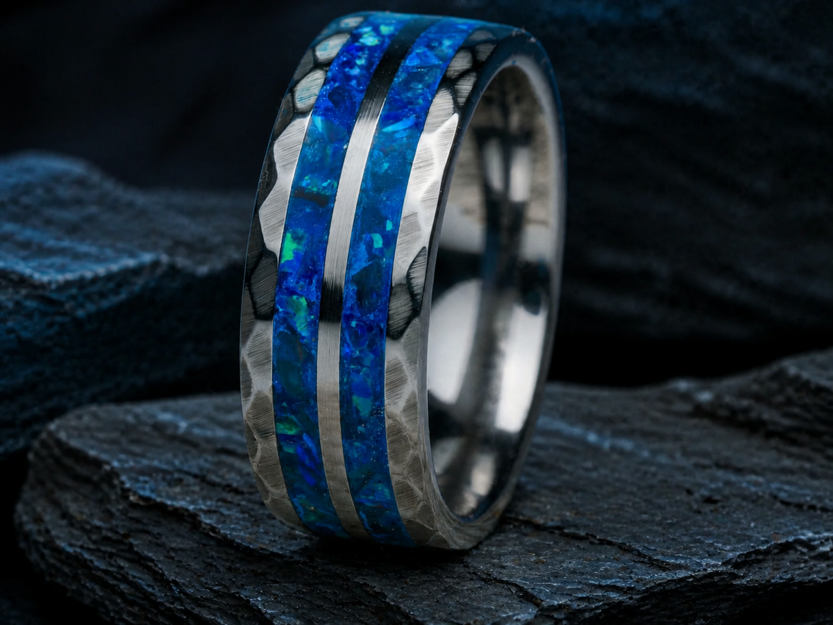 Neptune’s Anvil forged tungsten ring with deep ocean blue mineral inlay on layered black slate