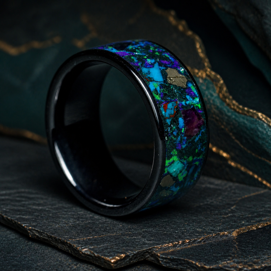Oceanfire Mosaic black ceramic mineral inlay ring on dark stratified slate with copper geological seams