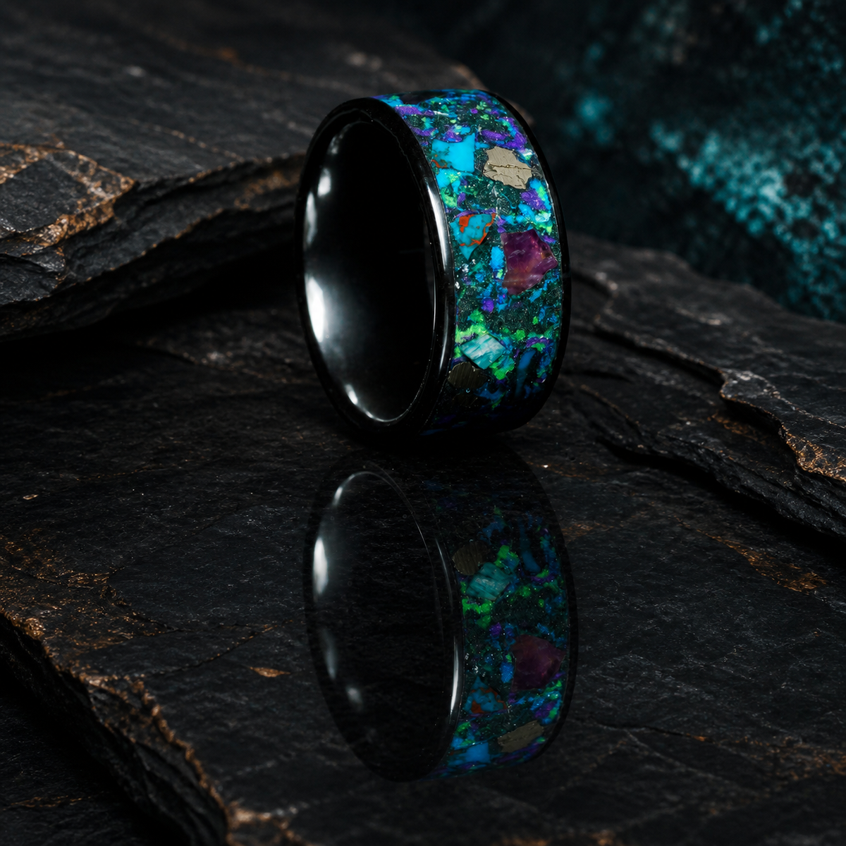 Oceanfire Mosaic black ceramic ring with blue green purple mineral inlay on reflective dark geological slate