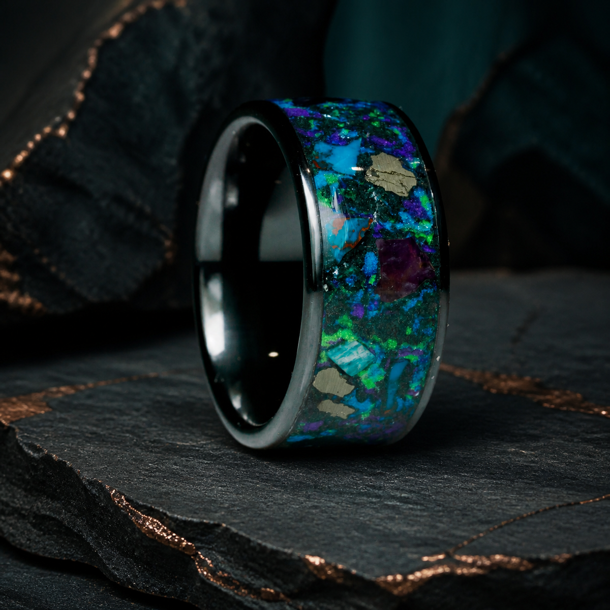 Oceanfire Mosaic three-quarter black ceramic mineral inlay ring on layered charcoal slate
