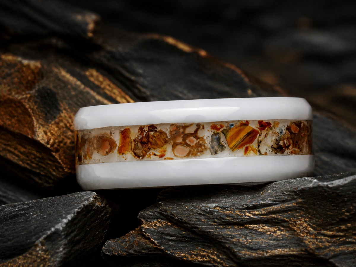 Paleogenesis angled fossil inlay ring detail on dark geological stone with amber accents
