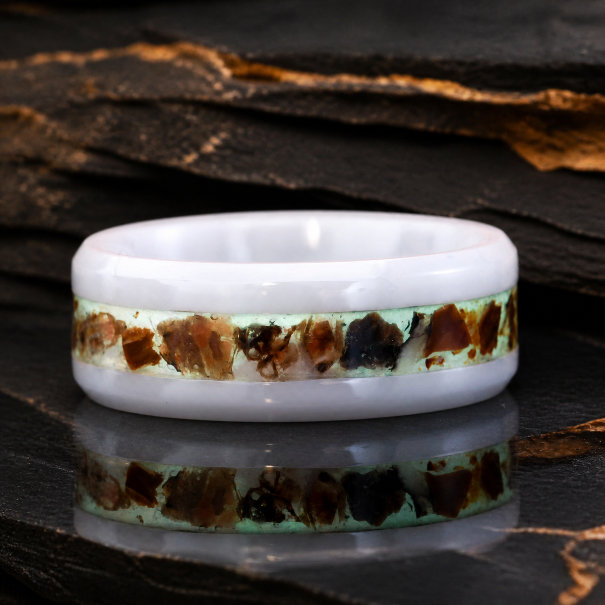 Paleogenesis luminous fossil inlay ring on dark slate with a subtle geological reflection