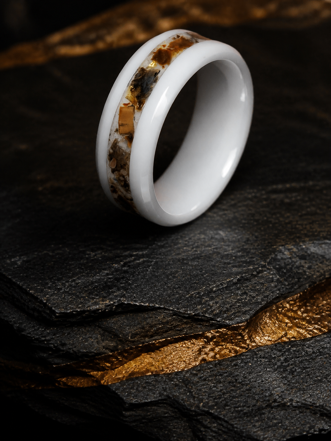 Paleogenesis three-quarter white ceramic fossil ring on dark stratified mineral stone