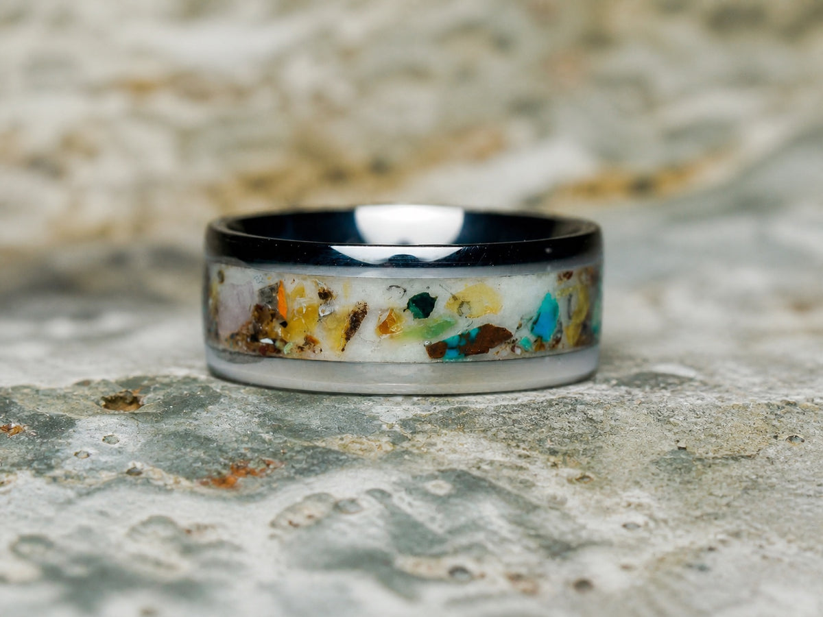 The Remnant Archive Ring among lapidary stone offcuts in daylight