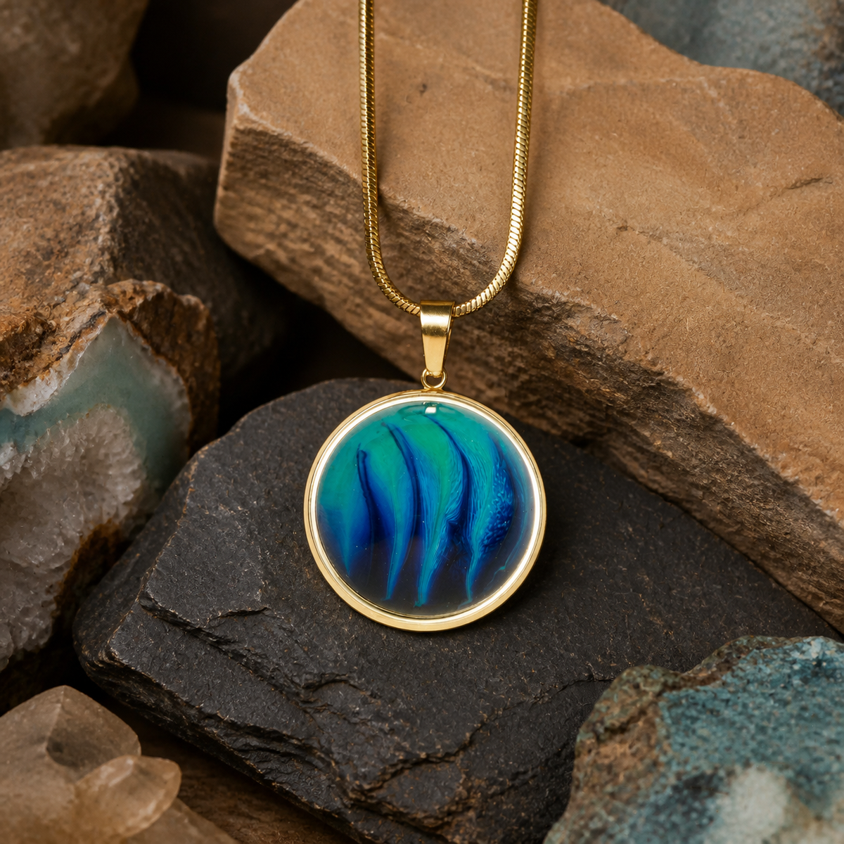18K gold plated round pendant with blue resin and ink art on earthy rock textures