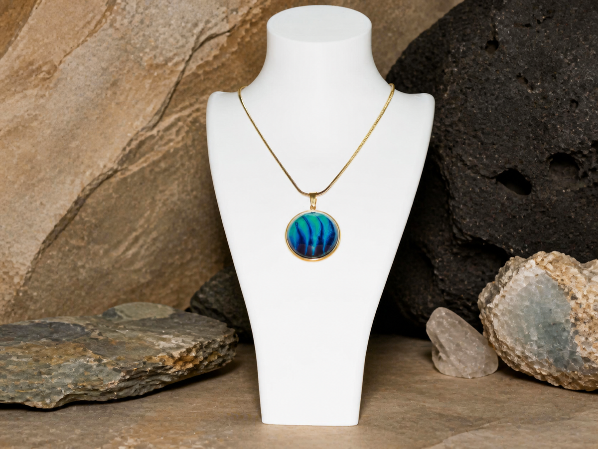 18K gold plated round pendant and 45cm chain displayed on a necklace bust with rocks