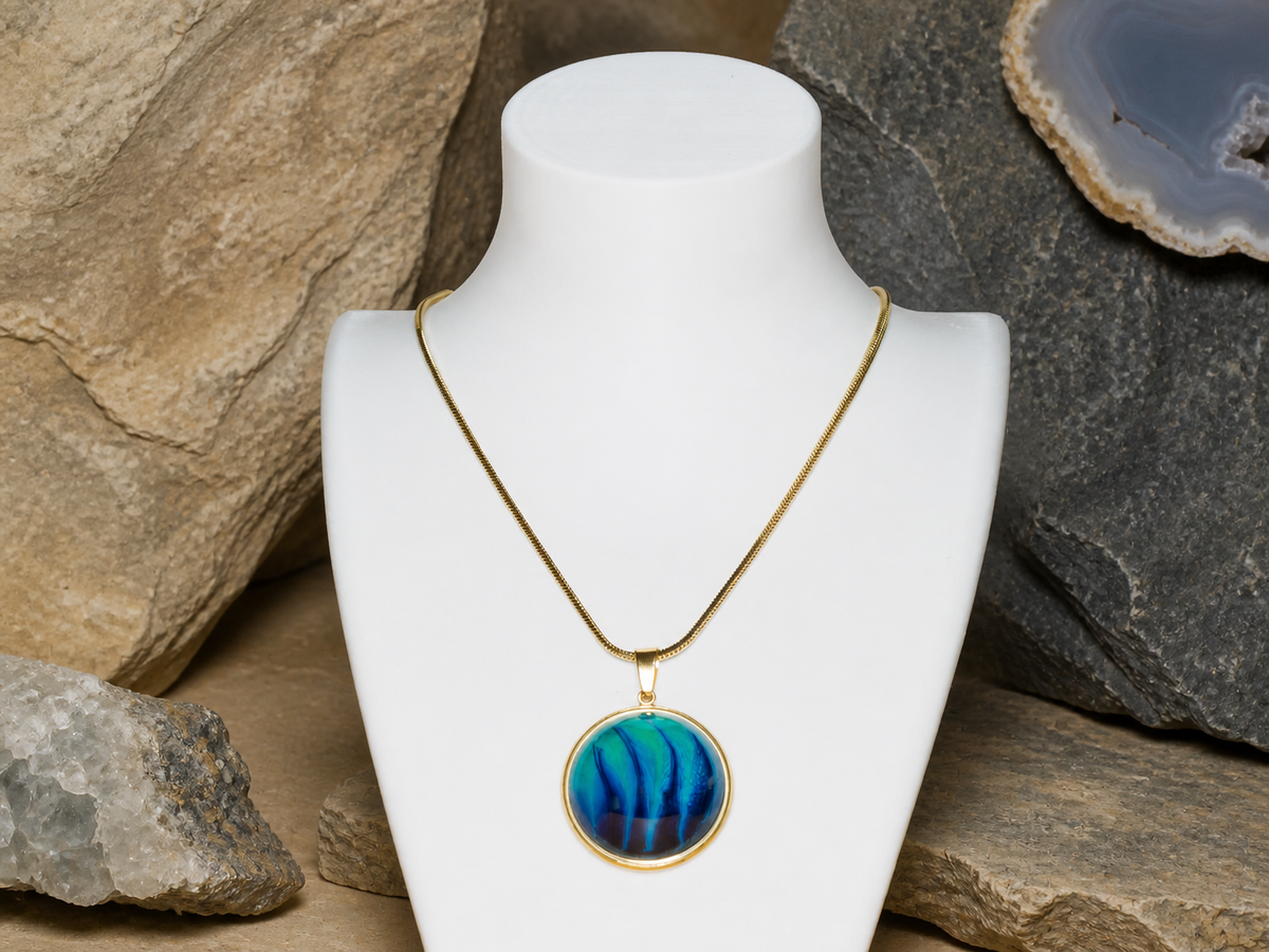 18K gold plated round pendant and chain on a mineral rock backdrop
