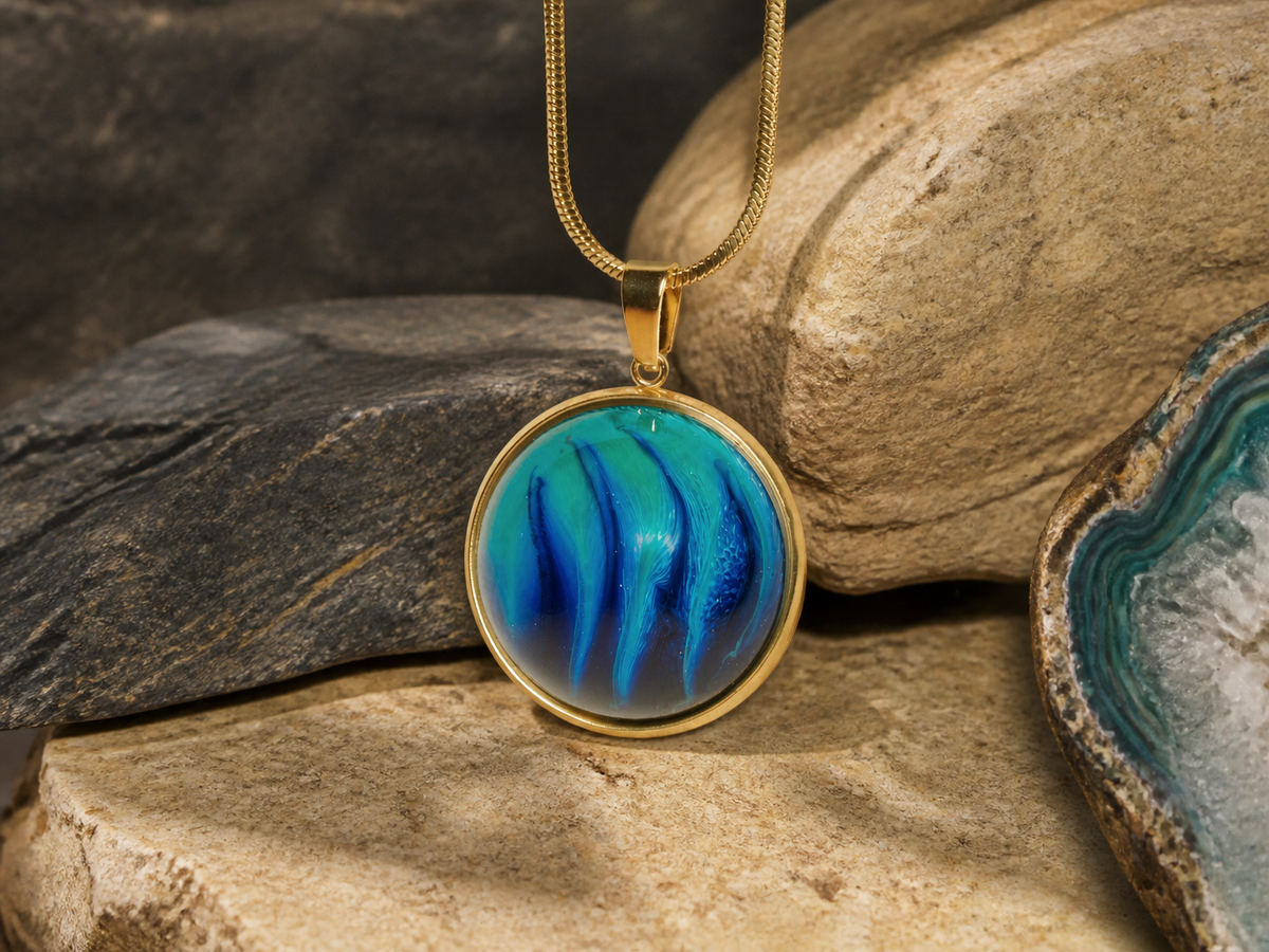 18K gold plated round pendant with resin and ink art framed by earthy stones