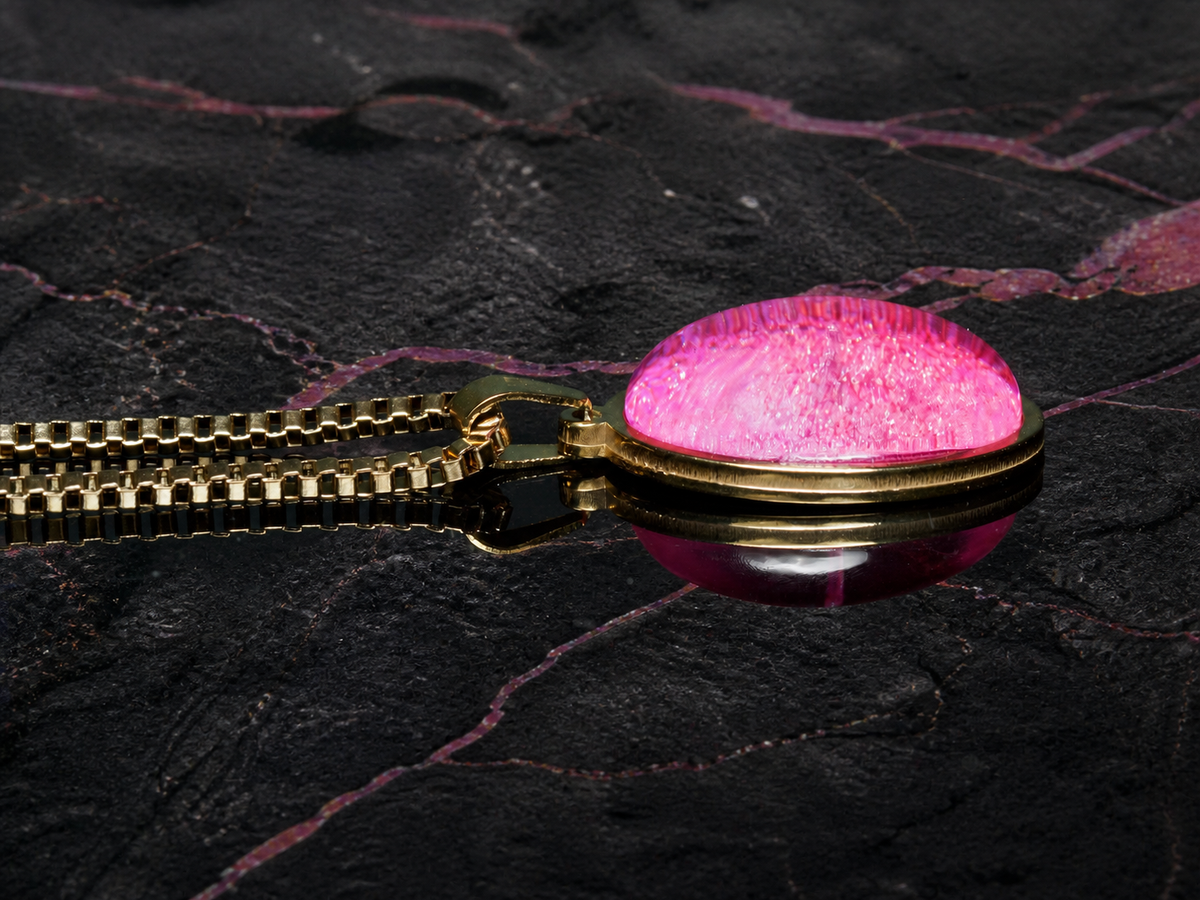 Side profile of the Rose Strata pink resin dome pendant and box chain