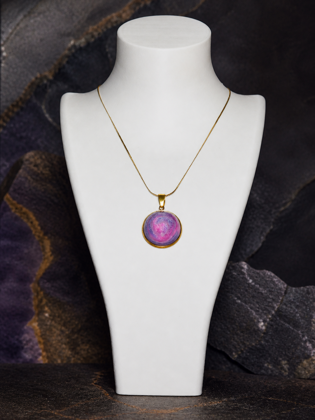 Rose Tide Orbit round 18K gold-plated pendant necklace on a white display bust against dark mineral stone