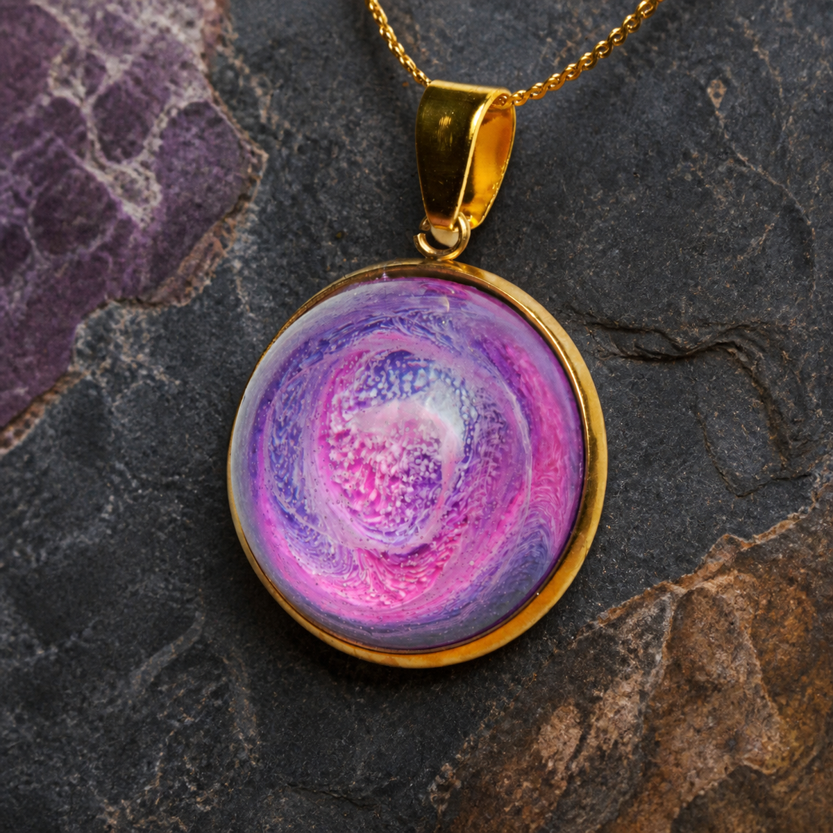 Close-up of the Rose Tide Orbit pink and violet alcohol-ink resin round pendant