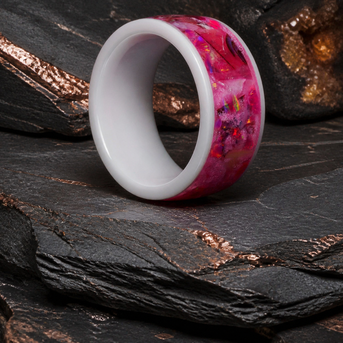 Rosetide Lumina pink shell and opal ring on dark stratified mineral stone