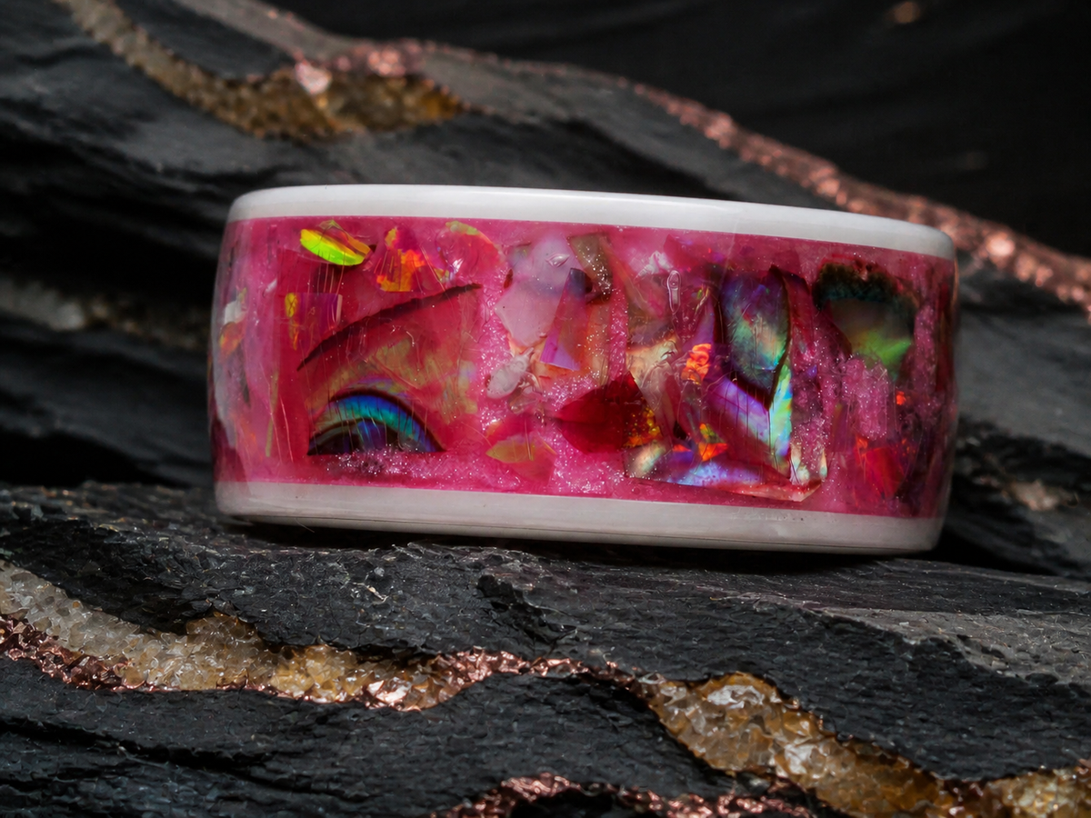 Close-up of the Rosetide Lumina pink iridescent inlay and white ceramic band