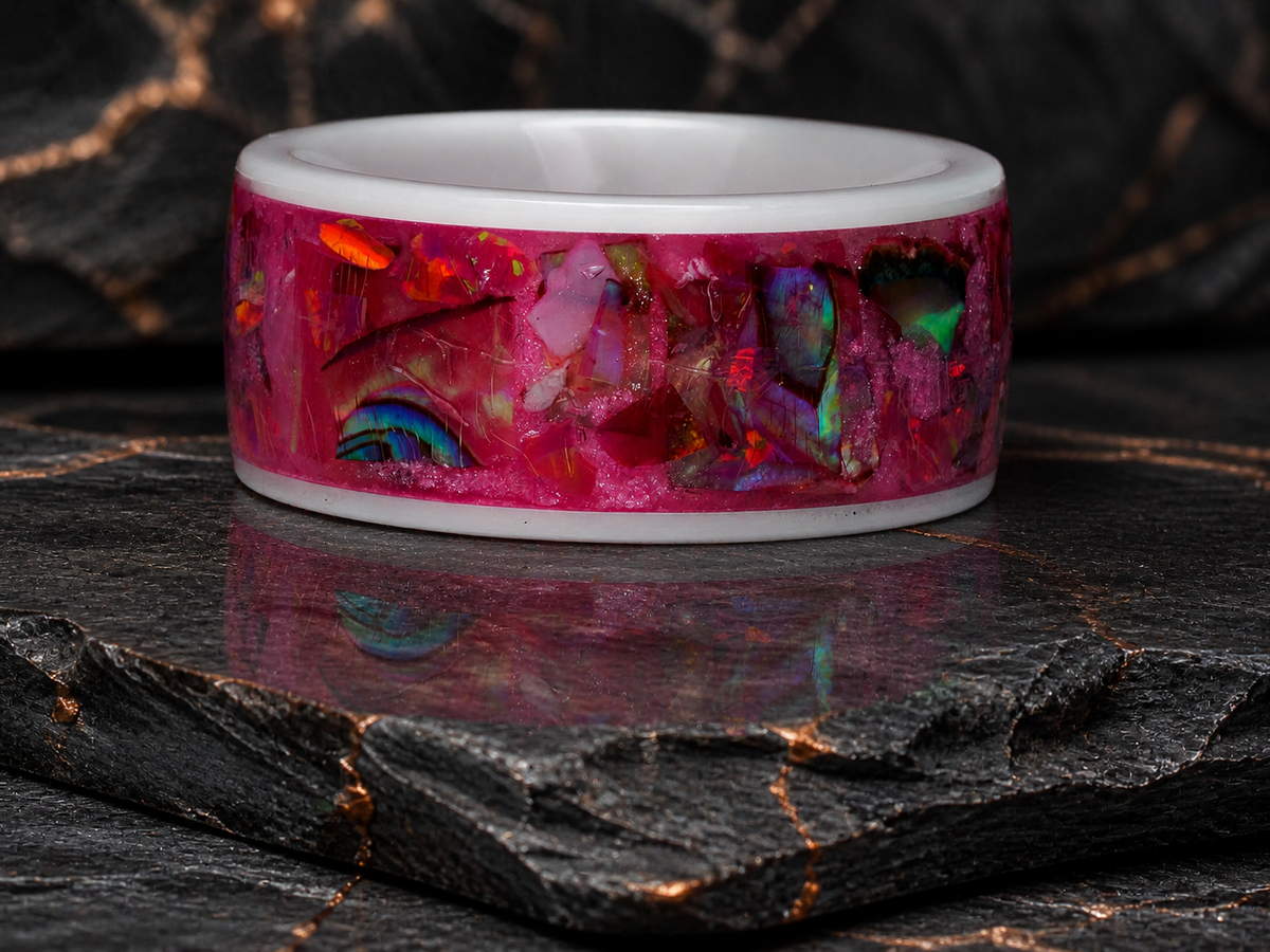 Rosetide Lumina ring front view with pink iridescent inlay on dark slate