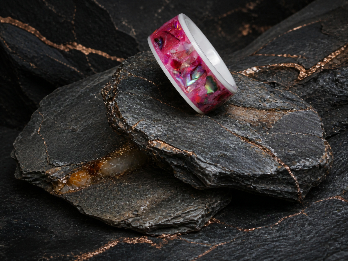 Rosetide Lumina ring resting on dark stratified mineral stone