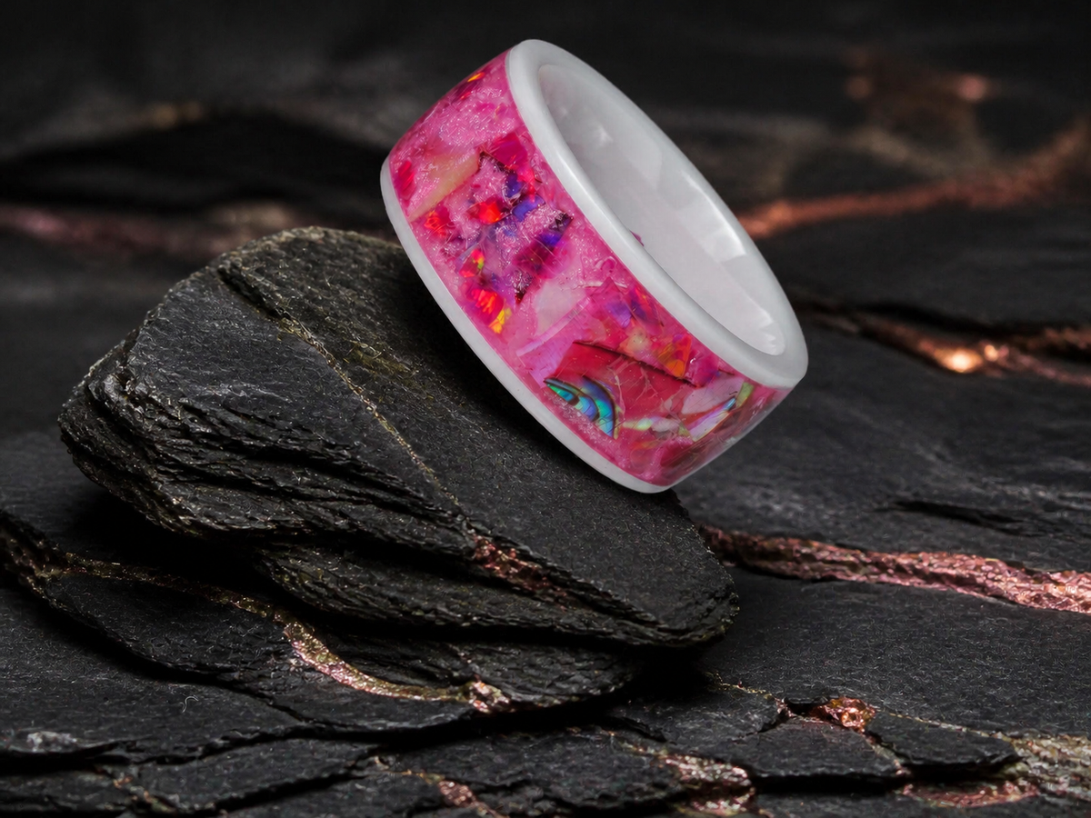Angled Rosetide Lumina white ceramic ring on dark geological slate