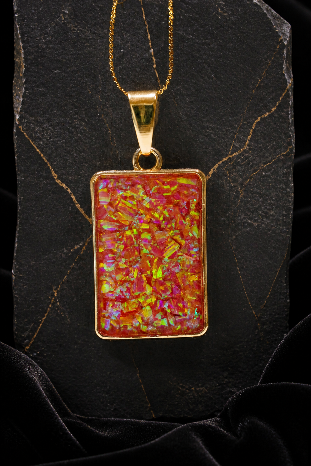 Solar Ember Prism pendant with full chain on black slate