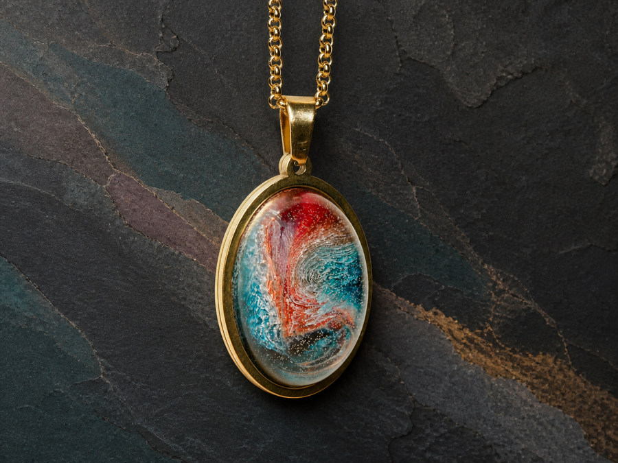 Thermal Rift 18K gold-plated oval pendant with fine gold chain on dark mineral slate