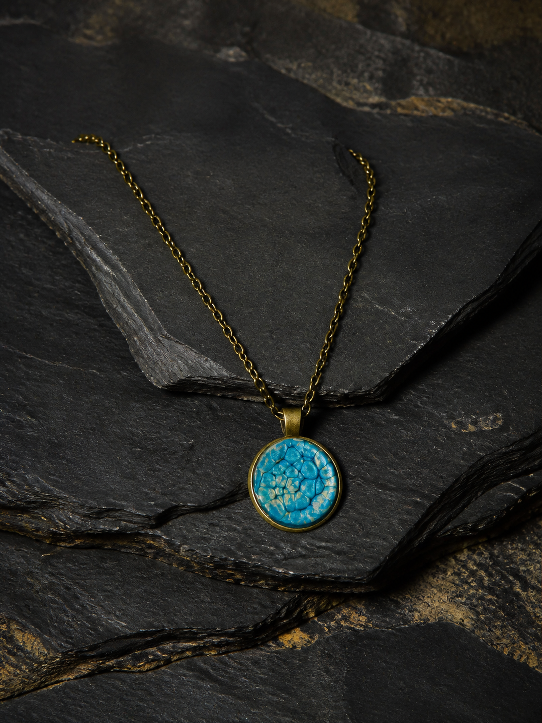 Thevenard Vein blue and antique-gold pendant necklace on dark geological slate
