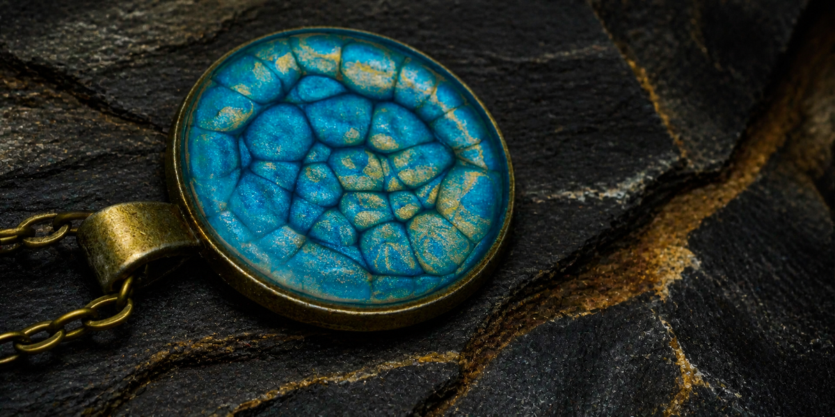 Close-up of Thevenard Vein blue pendant with antique-gold mineral details