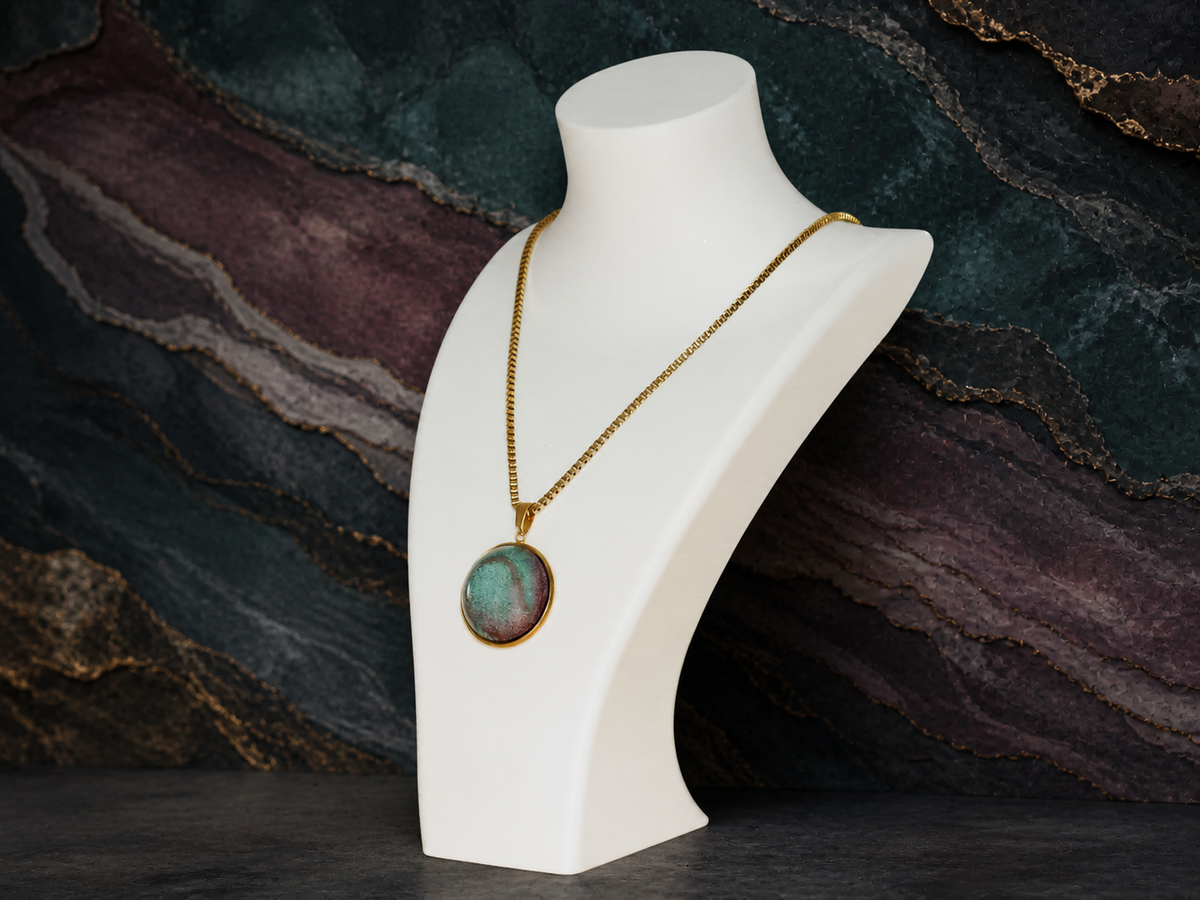 Angled display of the Tidal Patina gold pendant necklace on a white jewellery bust
