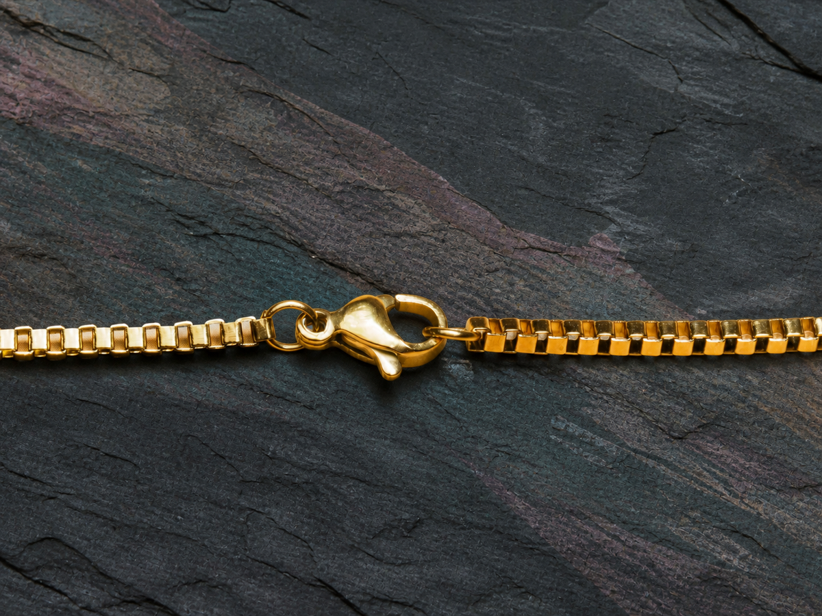 Lobster clasp and box-chain detail for the Tidal Patina gold necklace
