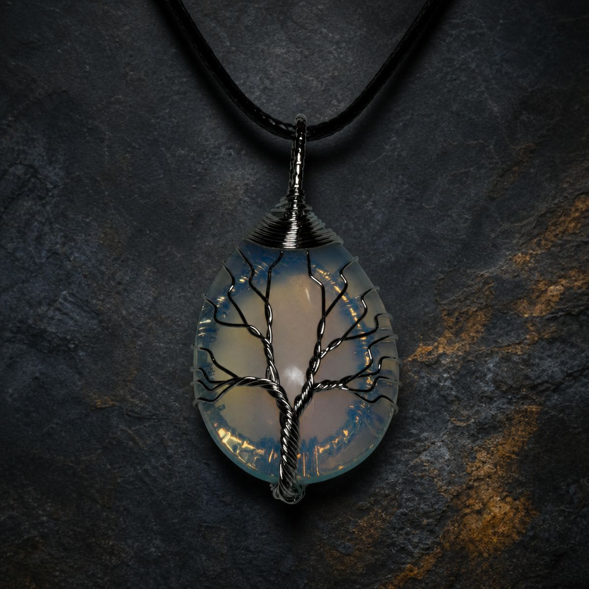 Blue Ember silver wire-wrapped Tree of Life pendant with blue and golden-yellow stone