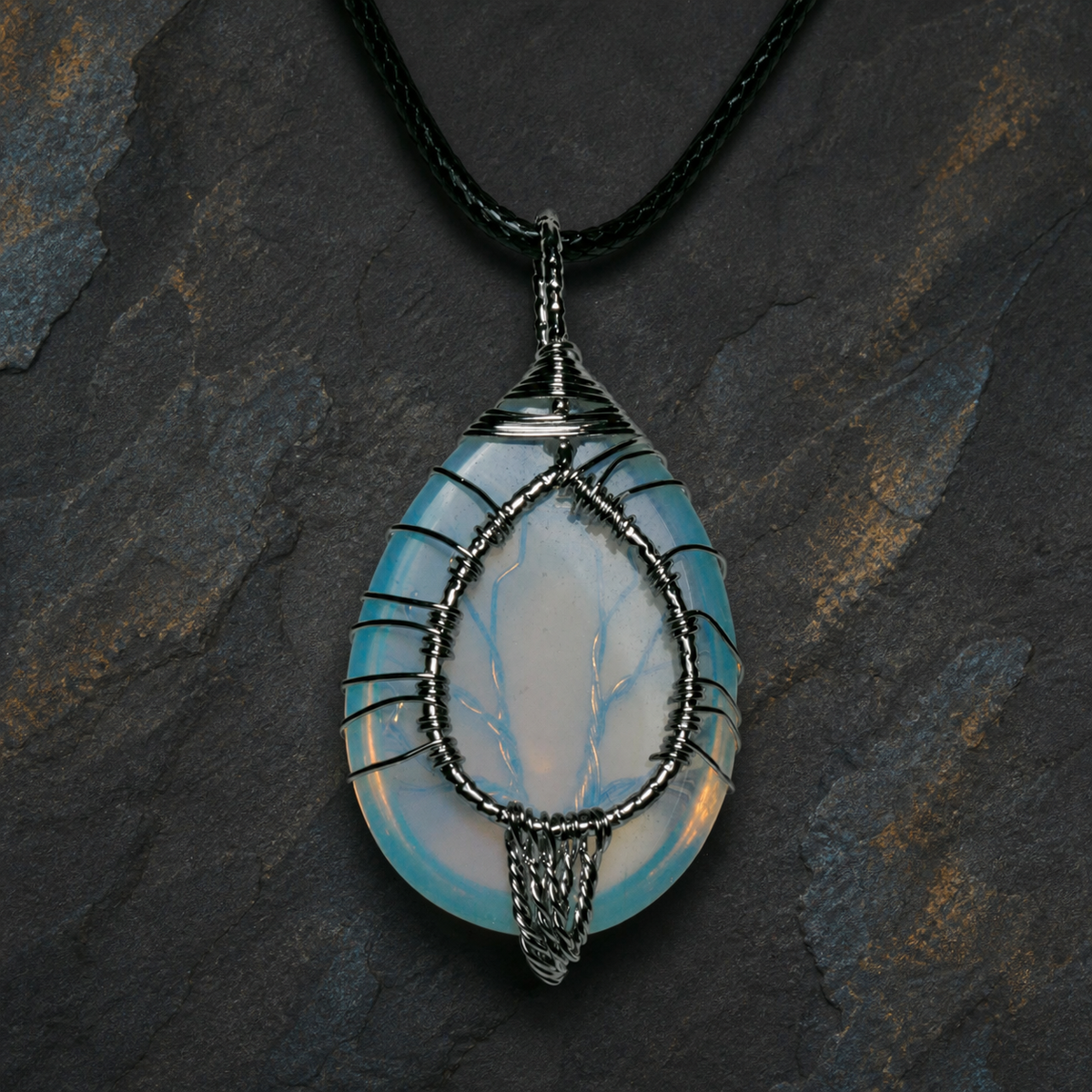 Blue Ember silver wire-wrapped Tree of Life pendant with blue and golden-yellow stone
