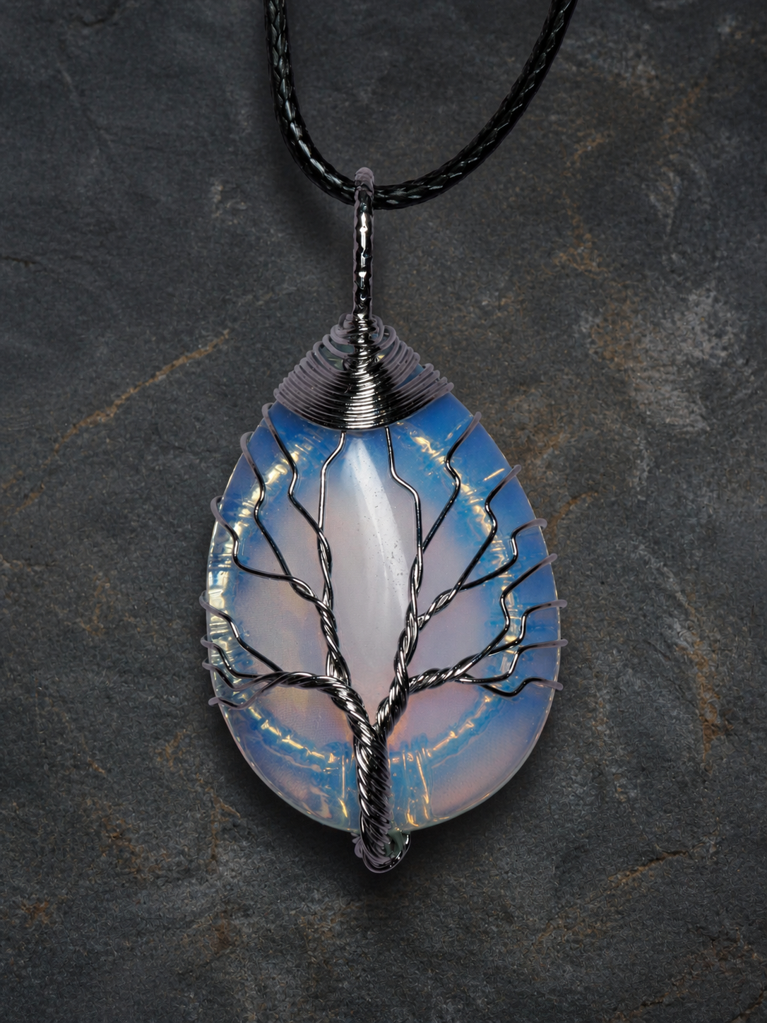 Blue Ember silver wire-wrapped Tree of Life pendant with blue and golden-yellow stone