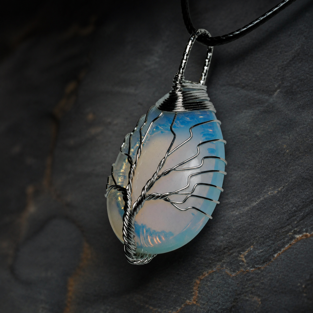 Blue Ember silver wire-wrapped Tree of Life pendant with blue and golden-yellow stone
