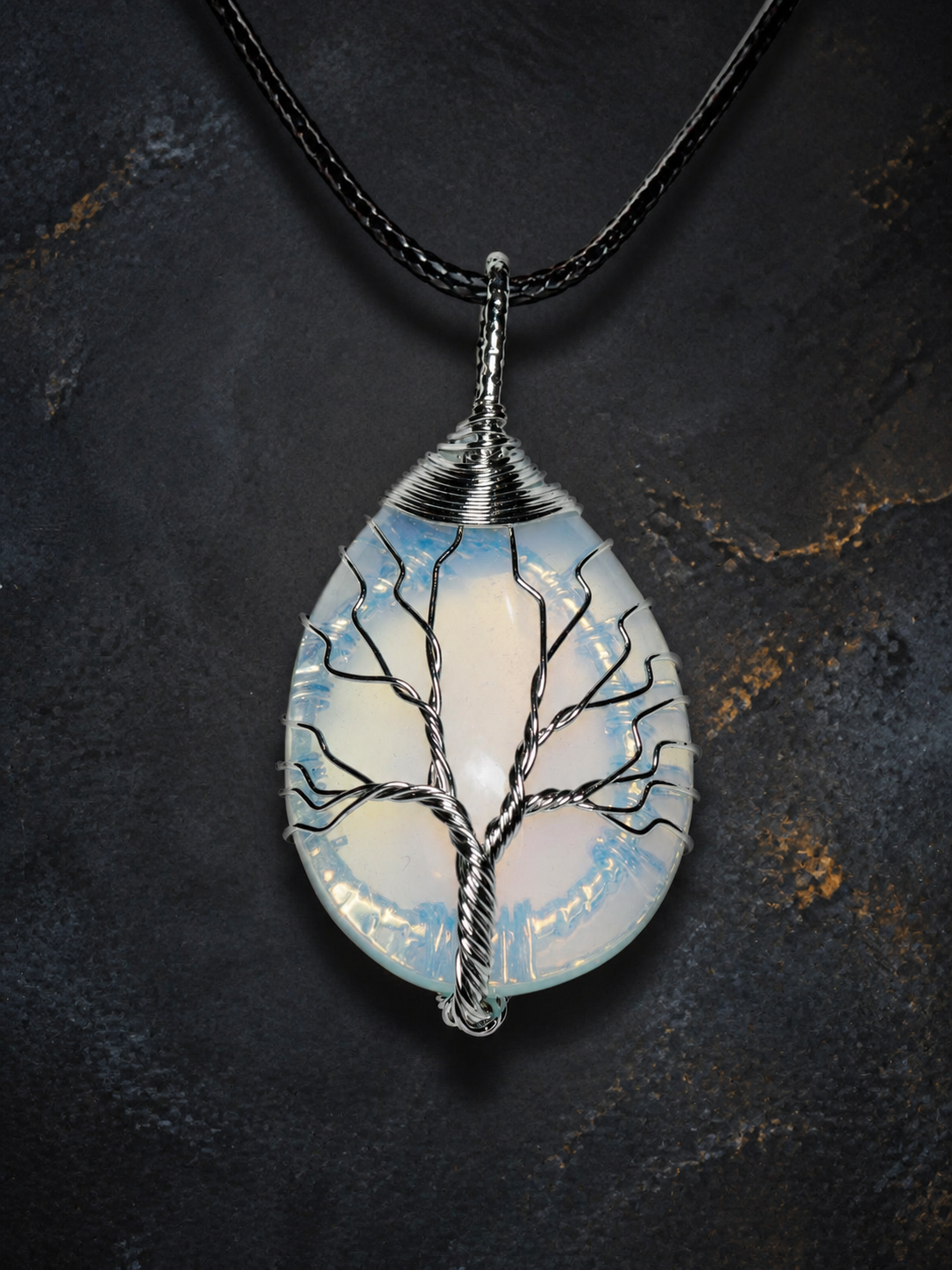 Blue Ember silver wire-wrapped Tree of Life pendant with blue and golden-yellow stone