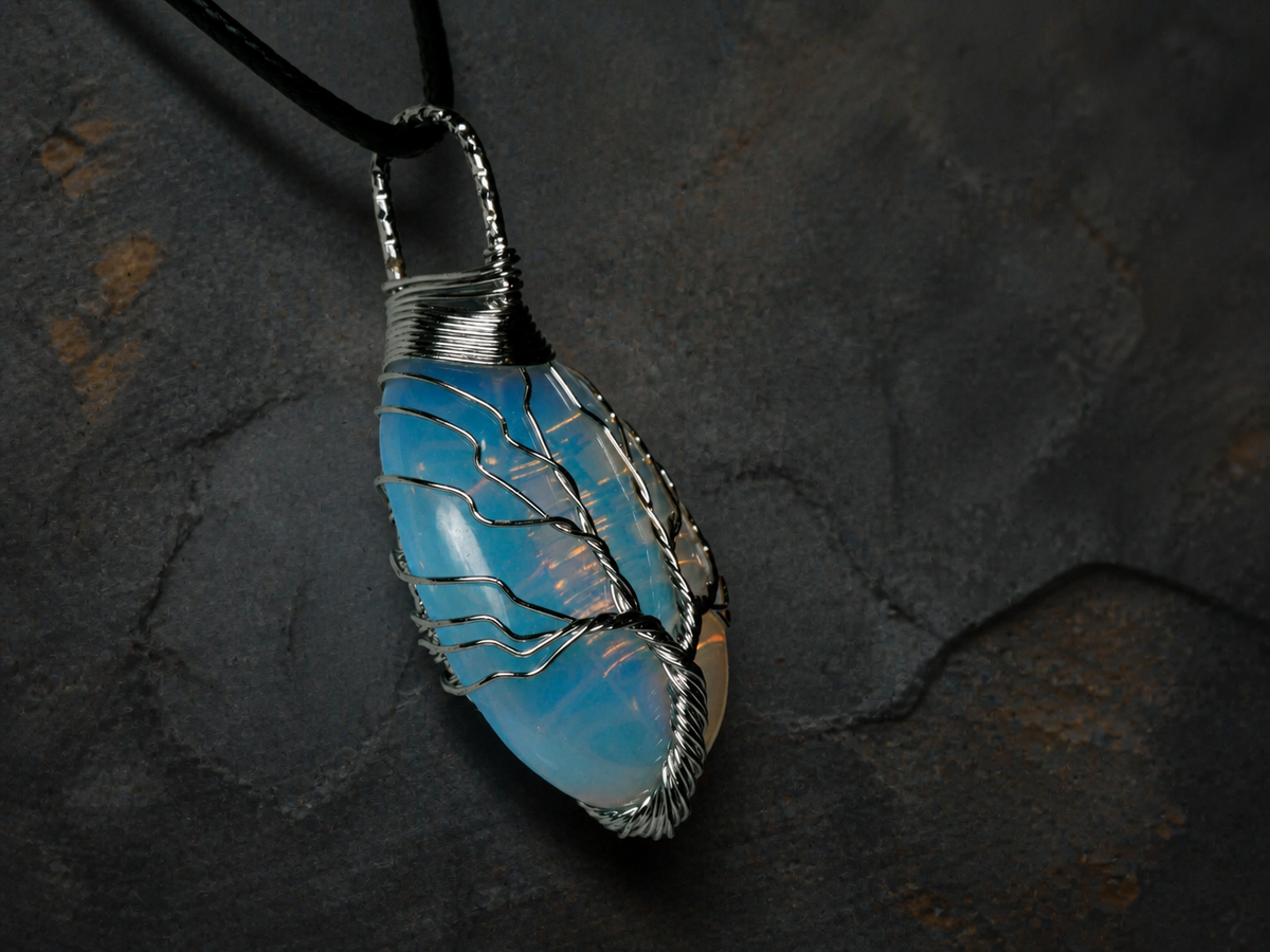 Blue Ember silver wire-wrapped Tree of Life pendant with blue and golden-yellow stone