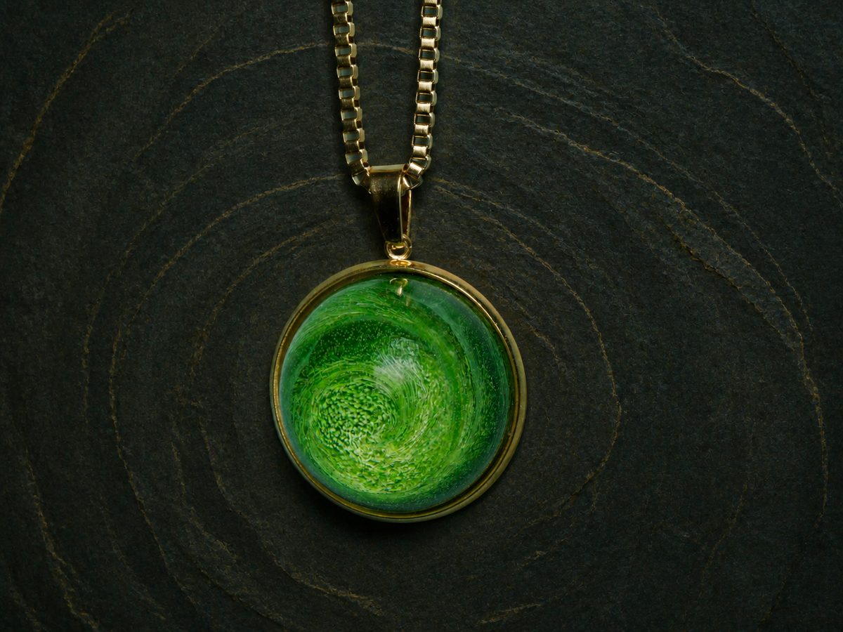 Verdant Eon emerald-coloured dome pendant on a dark mineral surface
