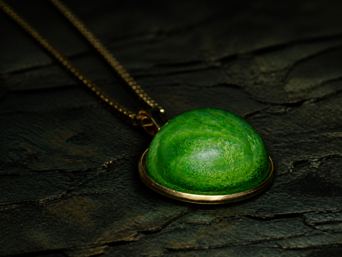 Close-up side view of the luminous emerald-coloured dome pendant