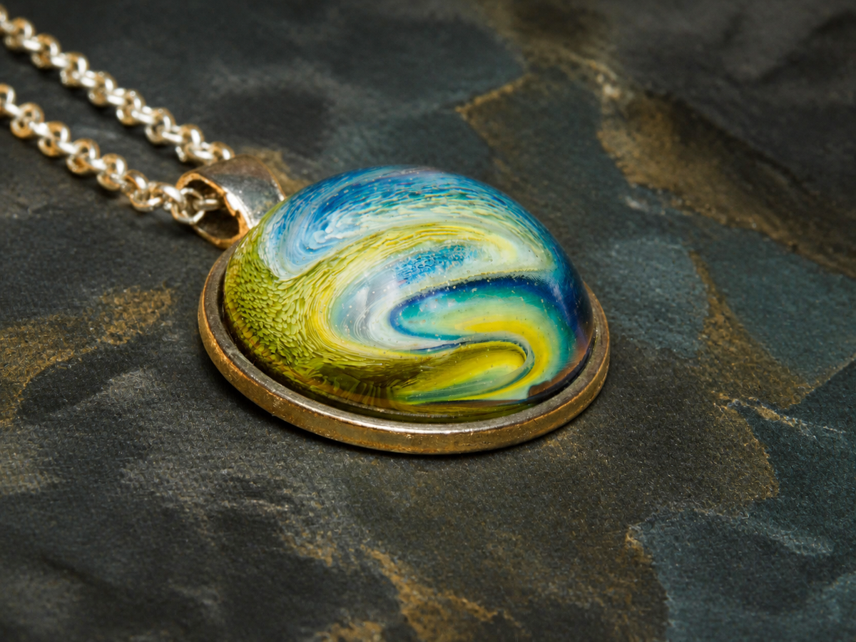 Side view showing the resin dome and silver-plated setting of the Verdant Gyre pendant