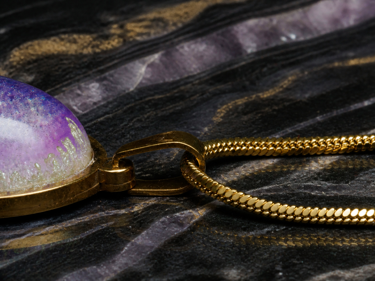 Violet Gyre pendant bail and gold-plated snake chain detail