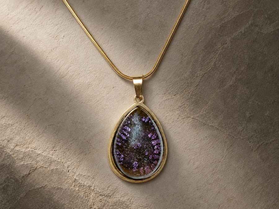 Close view of the Violet Orbit teardrop pendant and fine snake chain