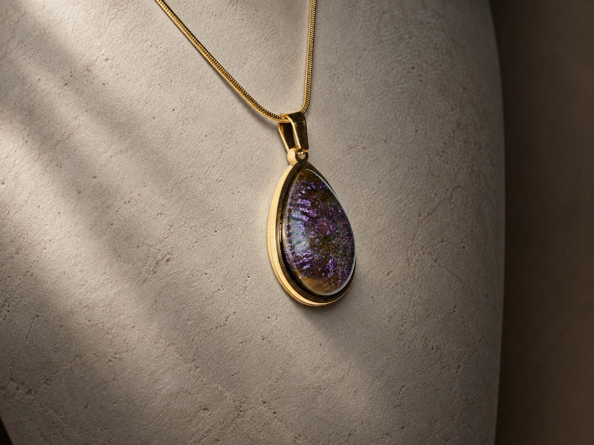 Angled hanging view of the Violet Orbit teardrop pendant necklace