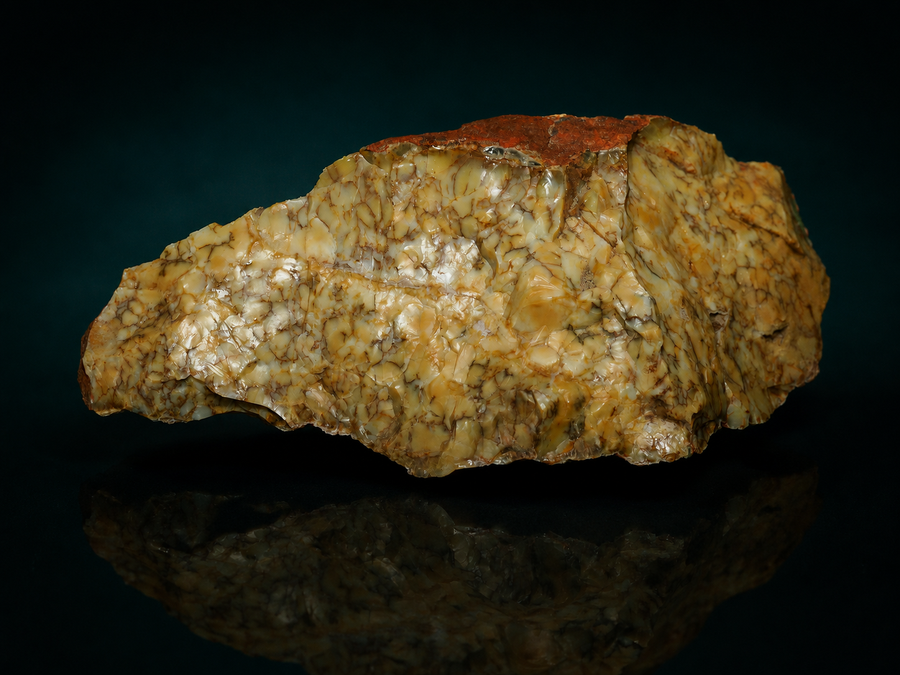 Yellow dendritic opalite specimen in red-brown matrix, front view